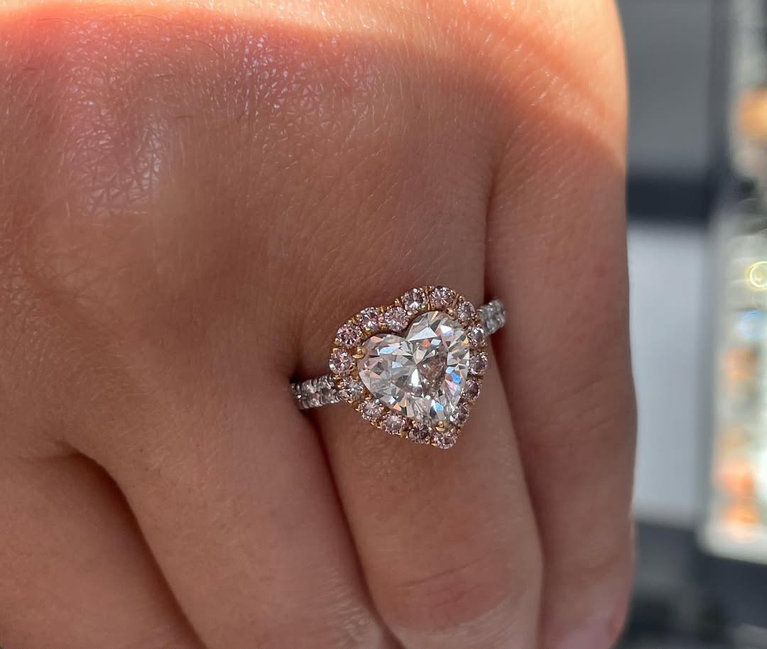 Capture her heart this holiday season with this heart shaped white diamond ring in pink diamond