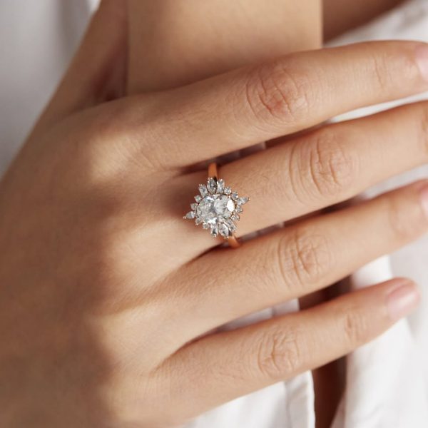 Crystal clear oval moissanite buds stand on four Marquise, four radiant, eight round moissanite,