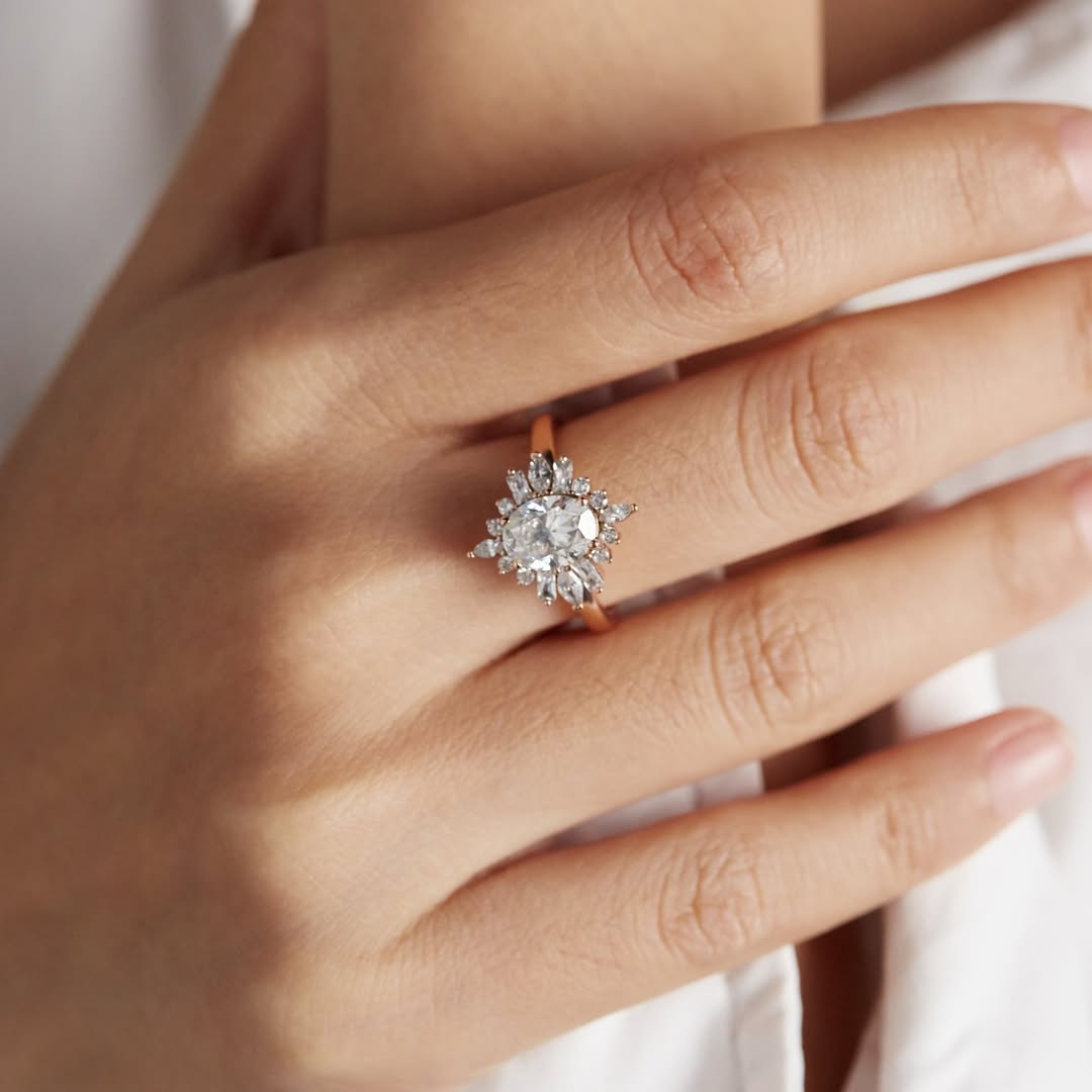 Crystal clear oval moissanite buds stand on four Marquise, four radiant, eight round moissanite,