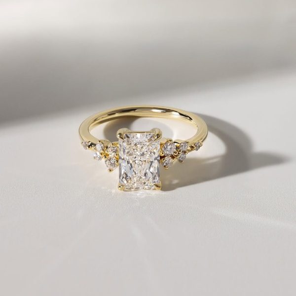 One of our most loved settings, reimagined with a radiant centre stone.Round accent side stones (2)