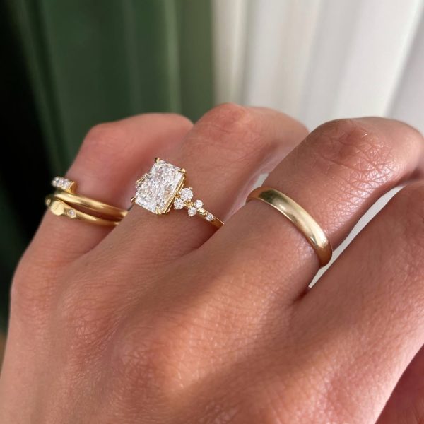 One of our most loved settings, reimagined with a radiant centre stone.Round accent side stones (3)