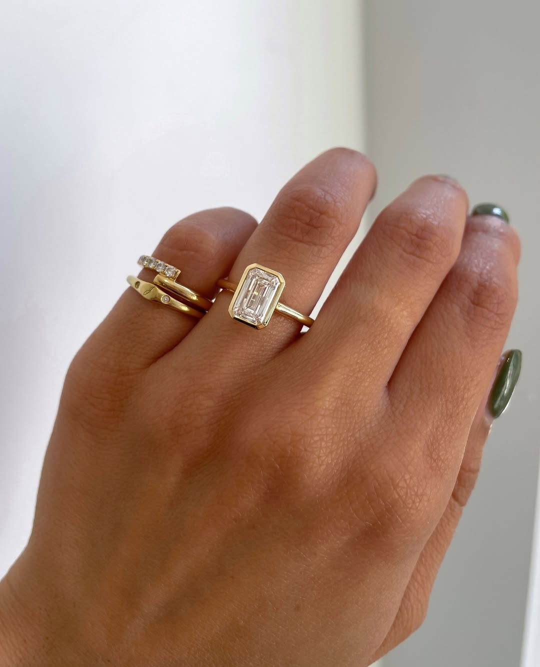 Ring stack inspiration for the gorgeous JOURNEE. An Emerald Bezel Solitaire paired with Cl